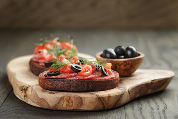 open rye sandwich with salami and vegetables