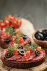 open rye sandwich with salami and vegetables