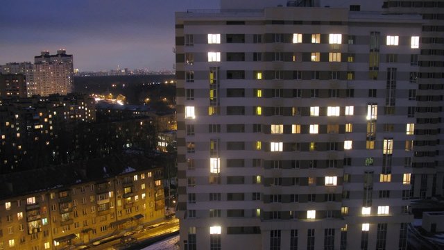 High-rise building seen at night. Timelapse
