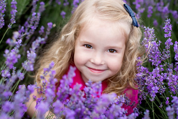 Fototapeta premium portrait smiling toddler girl in lavender