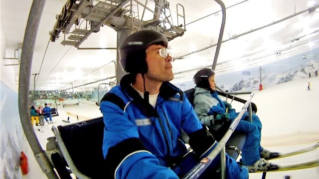 Father with son go on skilift in yearround ski complex