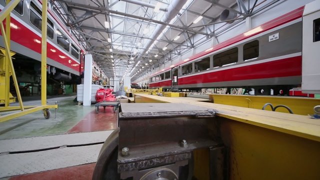 New trains at assemblage and journalists work at factory