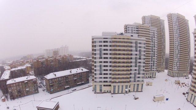 Wide view of a snowy city. Timelapse