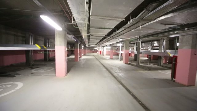 Large indoor two-level parking with electrolifts for many cars.