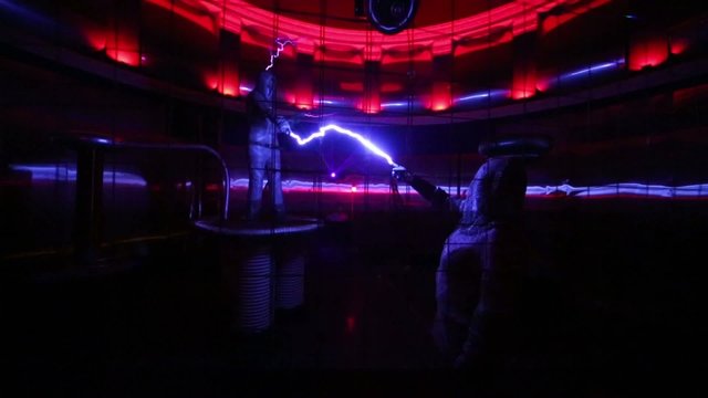 Two men in mail fight by artificial lightning at presentation