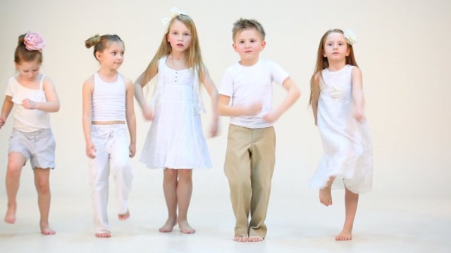 Five cute children marching on the spot isolated on white