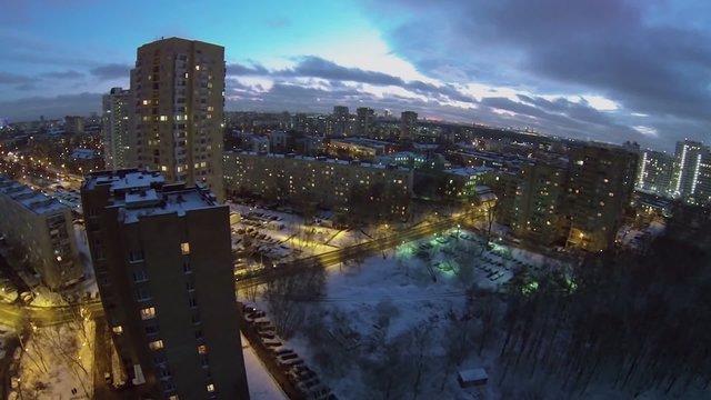Cityscape with traffic on street at winter evening 