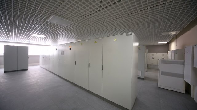 Light switched off and then turns on in room with rows of racks
