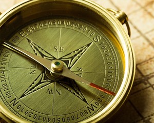 Abstract. Old compass on vintage map. Retro stale.