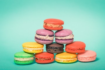 Fototapeta na wymiar Hipster. Sweet and colourful french macaroons on retro-vintage