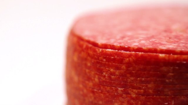 Cut and folded stack of circles revolve salami sausage
