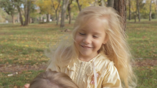 Mother with little daughter laughing and having fun in park