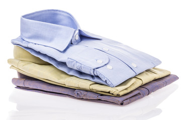 folded shirts on white with reflection