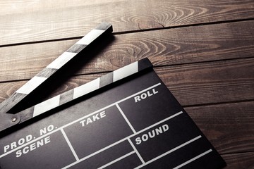 Production. vintage photo of movie clapper on wood