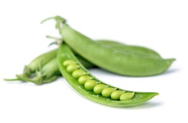 Closeup green peas on a white background