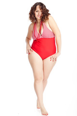 Beautiful woman in red swimsuit in studio