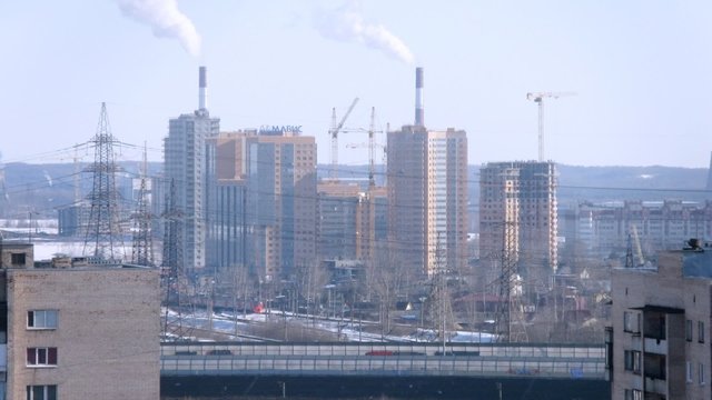 Aerial view on ring road in suburban area with traffic during the day, timelapse