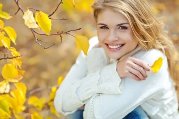 Poster Portrait of beautiful young woman walking outdoors in autumn  © nuzza11