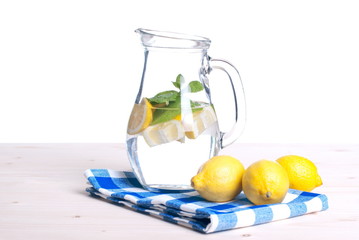 water with lemon and mint in a glass on the table side view of i