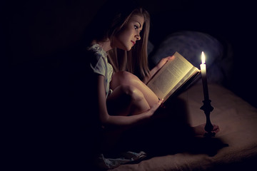 Beautiful woman with candle at home 