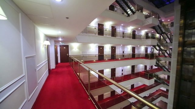 Dark review spacious hotel, elevators and floors with many doors