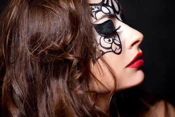 Fototapeta premium portrait of pretty brunette woman with face art