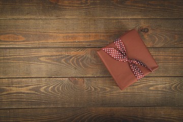 Fototapeta premium Gift. Vintage gift box with bow on wooden background