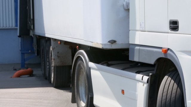 Long vehicle truck arrived to warehouse, closeup view