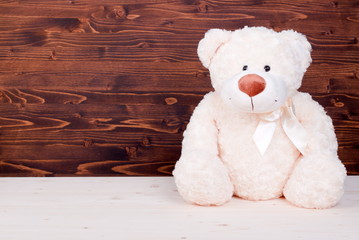 Obraz premium cute teddy bear toy on the board top view