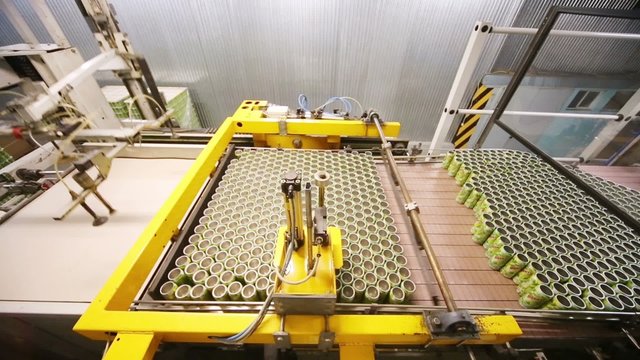 Many empty aluminum cans for drinks move on conveyor, above view