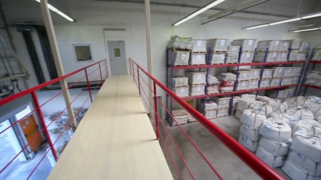 Small warehouse with lot of big white sacks
