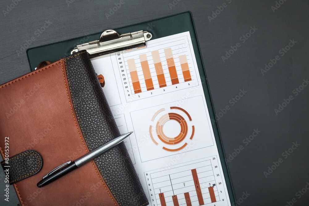 Wall mural Report. Financial graphs analysis on table