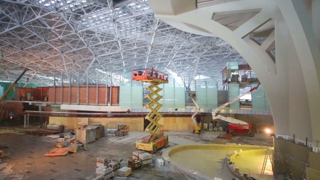 Scissor and telescopic lifts at construction site of terminal