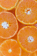 Conceptual background pattern of sliced juicy clementines