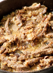 meat languor on a frying pan with sour cream