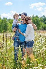 Young Attractive Parents and Child Portrait Outdoors