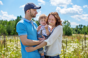 Obraz premium Young Attractive Parents and Child Portrait Outdoors
