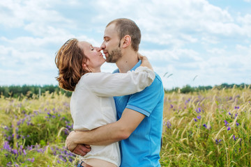 The happy couple has a rest in the field