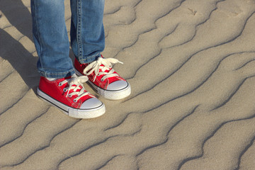childrens feet on sea sand.