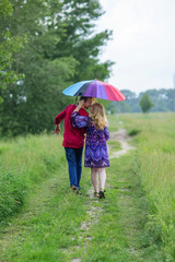 Pregnant couple under an umbrella