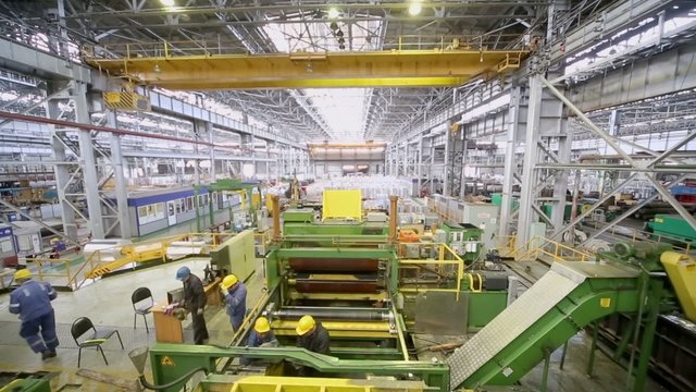 People work at adjustment of complicated machine 