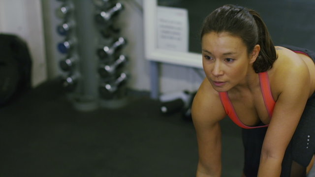 Beautiful woman lifting weights in slow motion