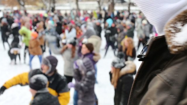 Teens are having fun throwing snowballs each other 