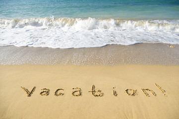 inscription vacation on sea sand beach
