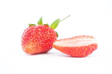 Closed up half of strawberry on white