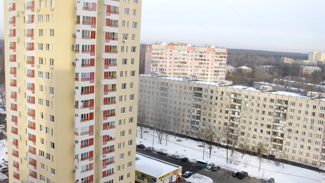 Aerial view of a high-rise building in a snowed city, timelapse