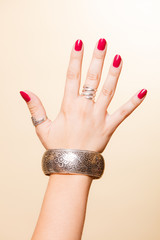 Female hand with manicure and armlet
