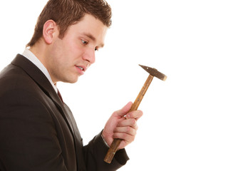 Pensive business man with hammer