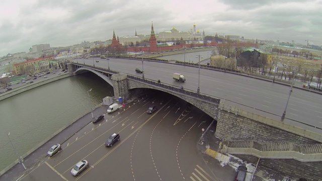Cityscape with traffic on bridge and quay near Kremlin complex