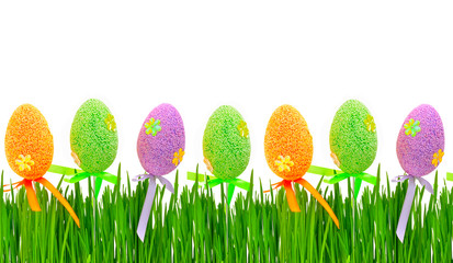 Fresh green grass and colored easter eggs